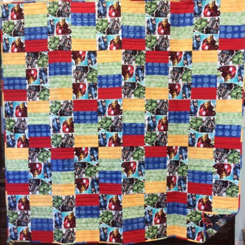 Large lap quilt featuring Marvel Avengers characters in rectangular blocks with primary color coordinating fabrics in brick pattern layout