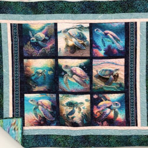 Lap quilt with nine sea turtle panels in iridescent colors, separated by black sashing with multiple borders