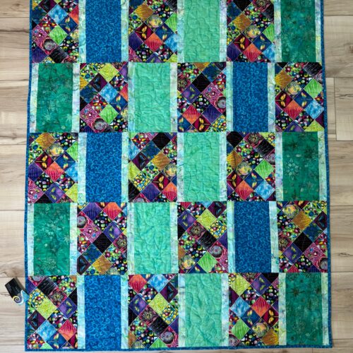 Children's Eye Spy quilt with rectangle blocks featuring colorful squares of fish, turtles, butterflies and other objects alternating with blue and green rectangles