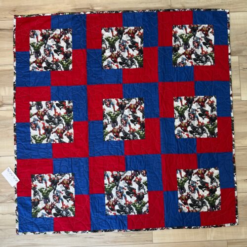 Avengers baby quilt featuring the iconic Marvel characters coordinated with bold red and blue tones on the front. The backing is a matching Avengers print.
