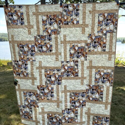 Cat Lover patchwork throw quilt in blue, tan, and off-white with a focal print of cats on a blue background.