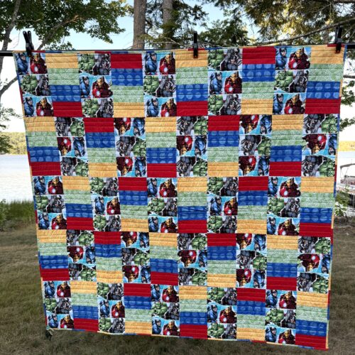 Throw quilt featuring Marvel Avengers characters in rectangular blocks with primary color coordinating fabrics in brick pattern layout