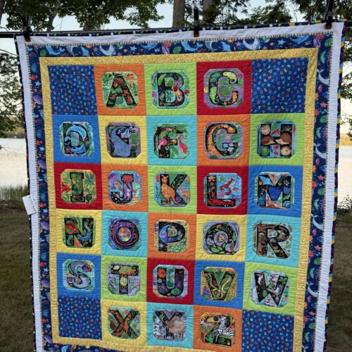 Child's Alphabet panel quilt featuring colorful animals for each letter