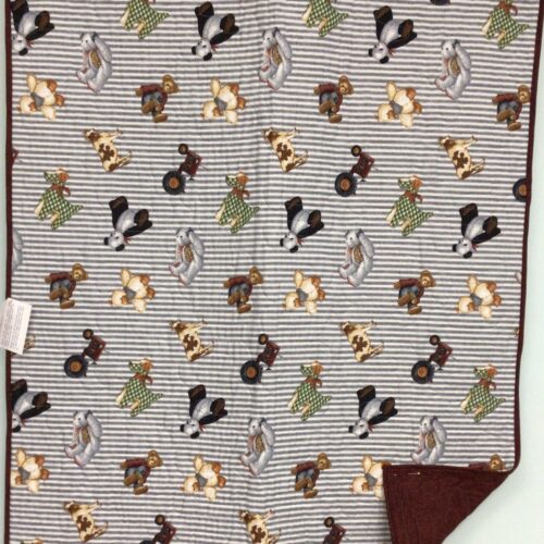 Baby quilt with toy teddy bears, farm animals, dogs, and pandas scattered across gray and white horizontal striped background