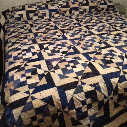 King bed quilt based on Evelyn Sloppy's Honey Berries pattern in blues and tans with herringbone quilting