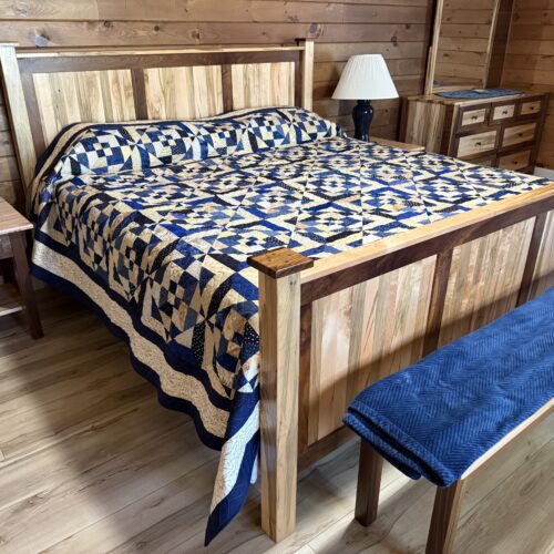 King bed quilt based on Evelyn Sloppy's Honey Berries pattern in blues and tans with herringbone quilting